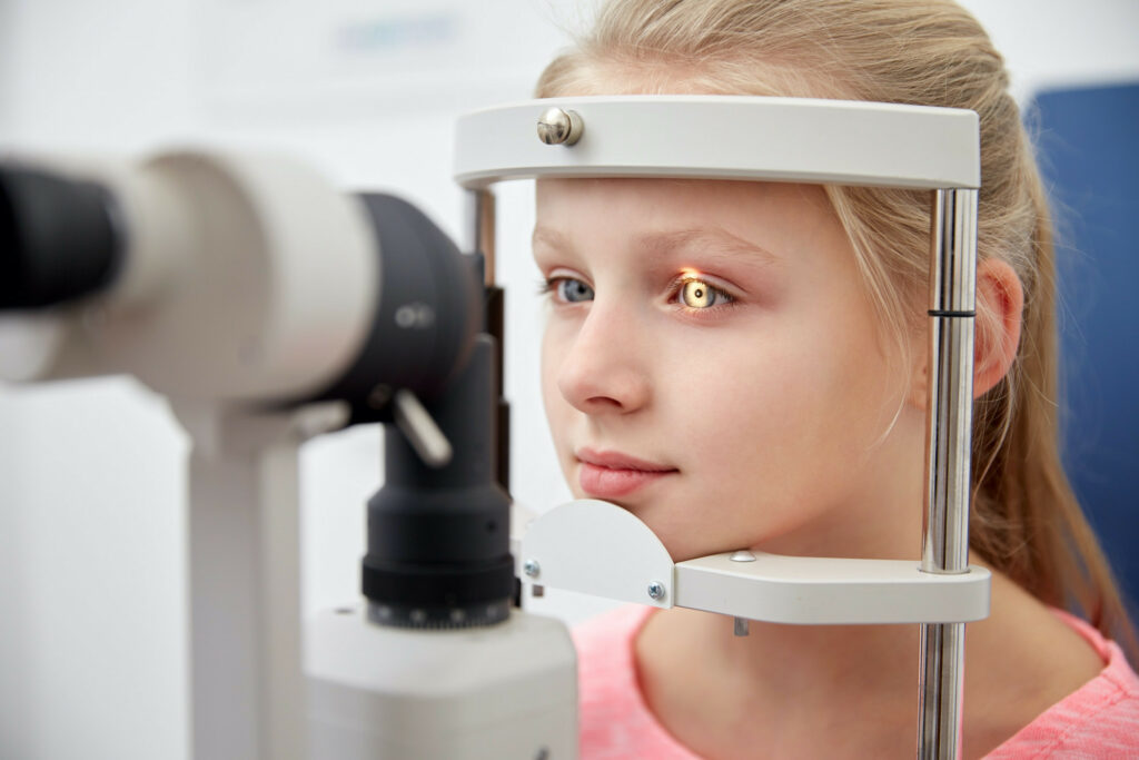 girl checking vision with tonometer at eye clinic