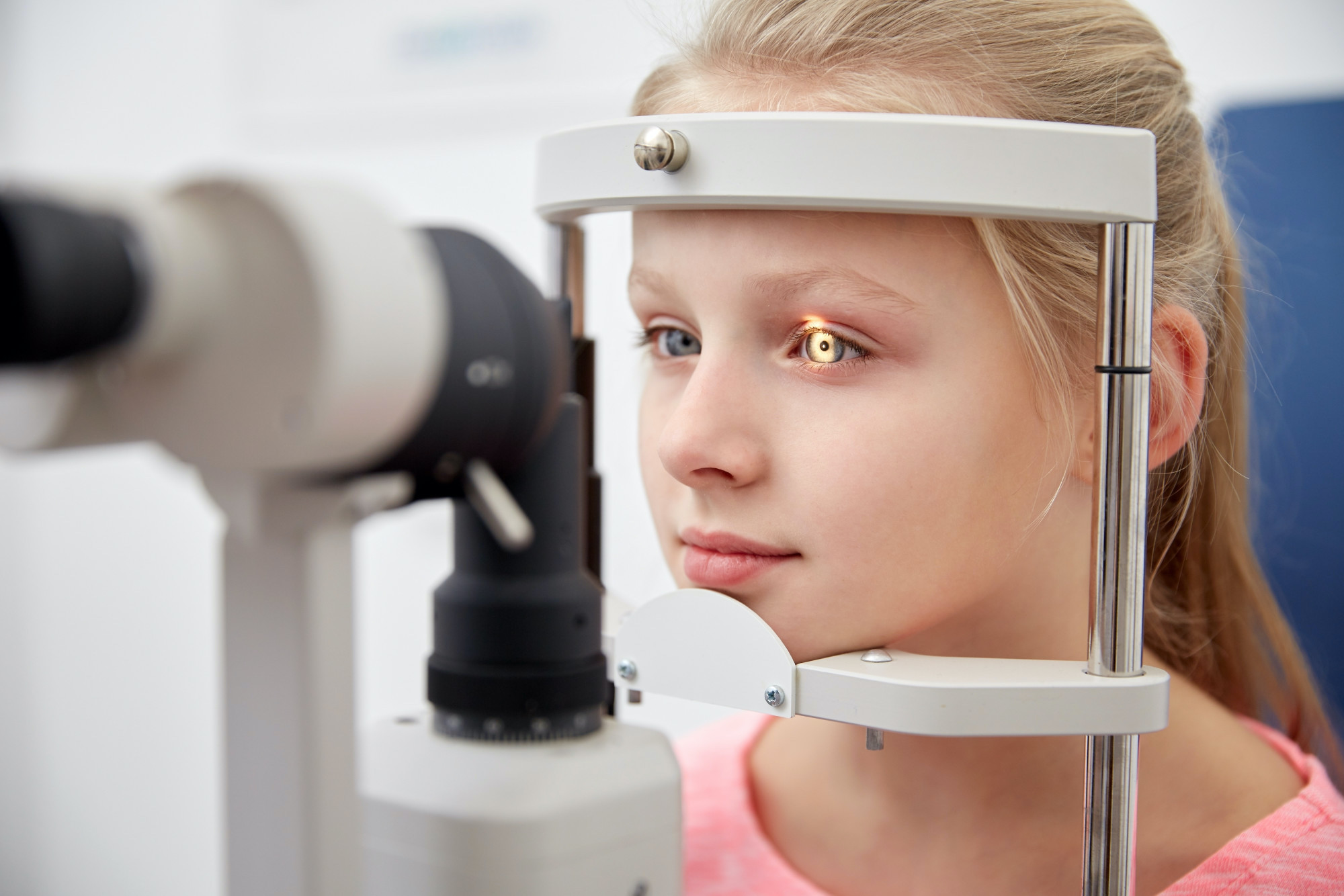 girl checking vision with tonometer at eye clinic