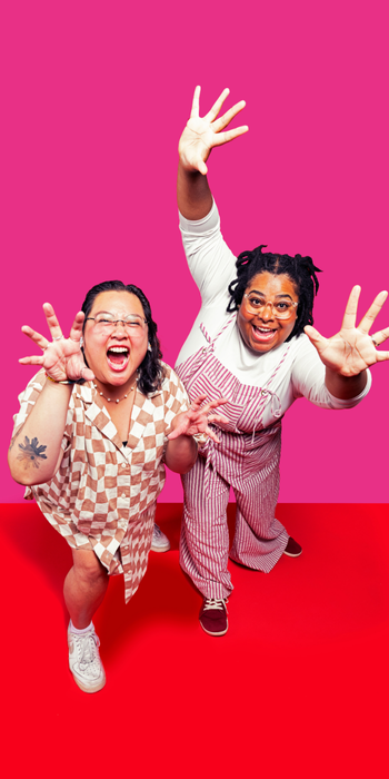 Two Happy People reaching toward the camera and smiling