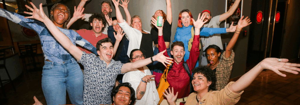 a group of artists and audience members celebrating